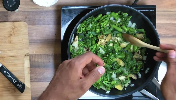 Cover the pan with a lid and let it cook to ensure the broccoli cooks properly. Mix everything together to combine flavors.