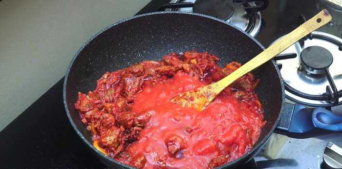 Add canned tomatoes (roughly chopped) and 2 cups of water or stock. Bring to a simmer, cover, and cook for about 25 minutes.
