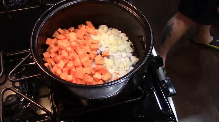 Add diced sweet potatoes to the onions and cook for a few minutes.