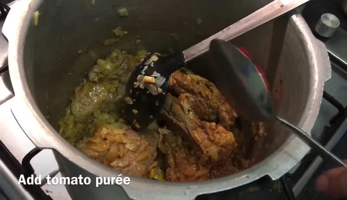 Add tomato puree and mix well.