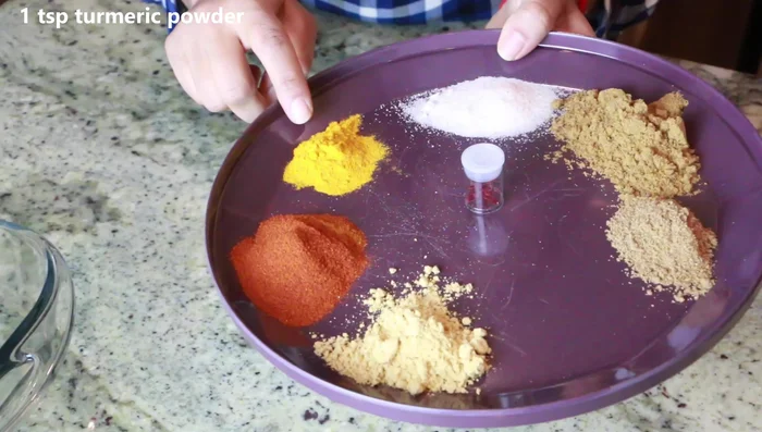 Combine coriander, cumin, salt, turmeric, paprika, ginger, parsley, lime zest, and grated garlic in a bowl.