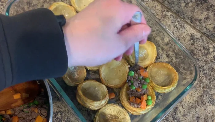 Scoop out the center of each fried artichoke heart to create a space for filling.