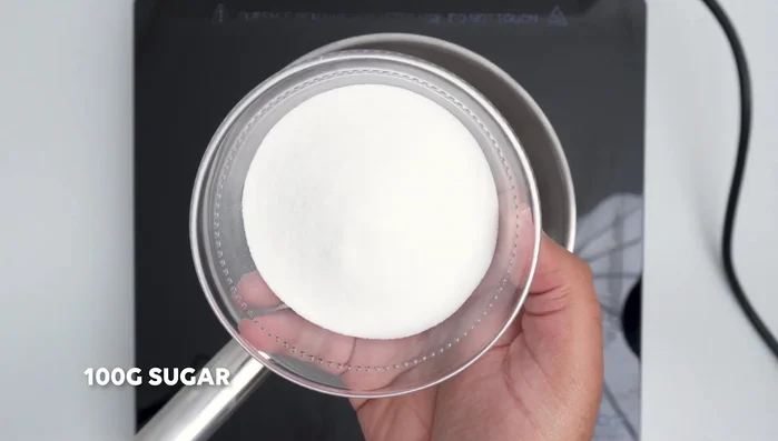 Make caramel topping by melting sugar, adding butter and heavy cream.