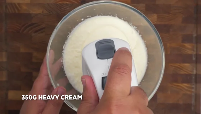 Whip heavy cream and sugar to stiff peaks.