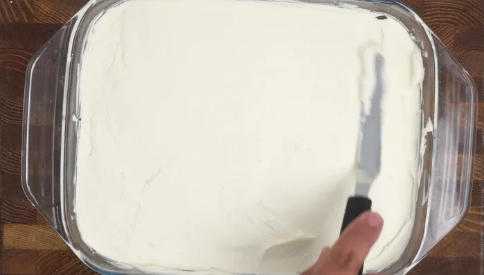 Spread whipped cream on the soaked cake, then caramel sauce, and decorate with piped whipped cream and garnish.