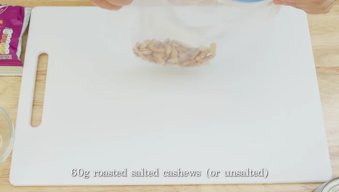 While the bulgur cooks, prepare the other ingredients: coarsely crush cashews, chop apricots, thinly slice spring onions, and cut tomatoes into small pieces.