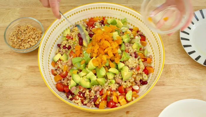 Add the avocado, apricots, cashews, parsley, and mint. Pour the dressing over the salad and toss everything together.