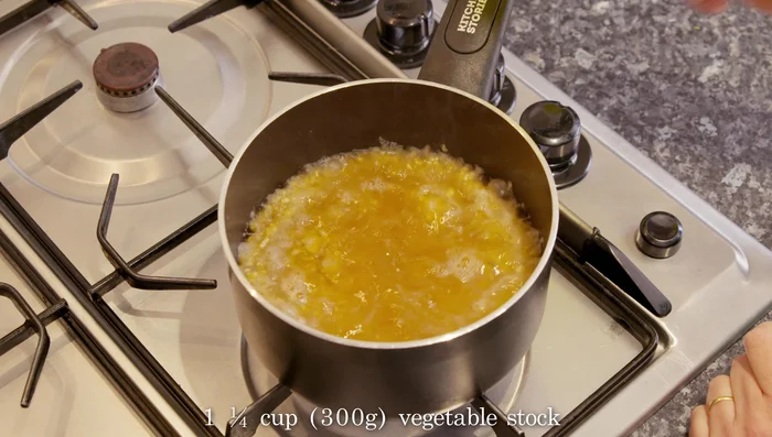 Add the vegetable stock, bring to a boil, cover, and turn off the heat. Let it sit for at least 20 minutes to allow the bulgur to cook by absorbing the liquid.