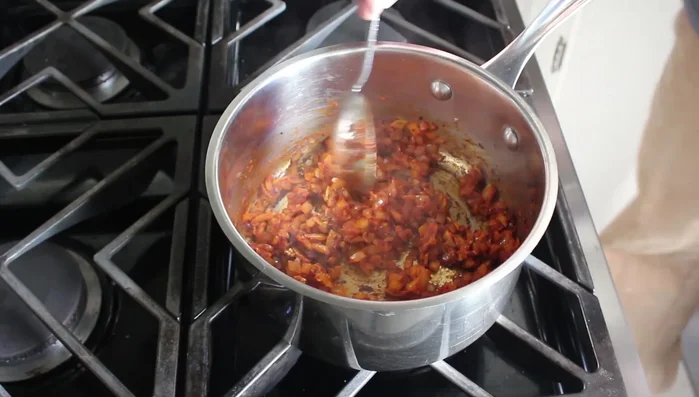 Add chicken or vegetable broth (or water). Stir and bring to a simmer.