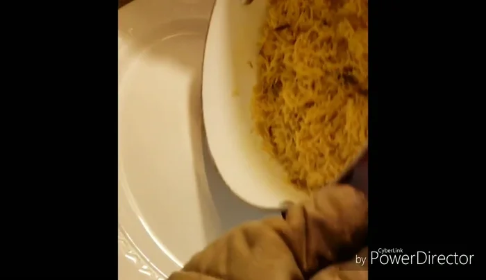 Place the spiced rice on a serving plate, arrange the fried fish around it, and top with roasted nuts.