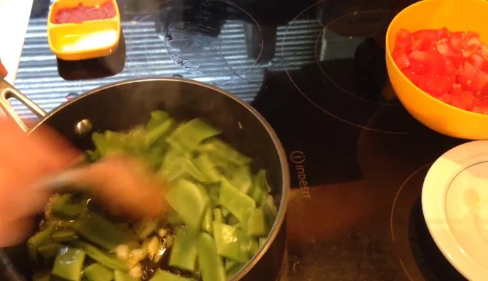 Add the chopped green beans, mix well, cover, and cook for 5 minutes.