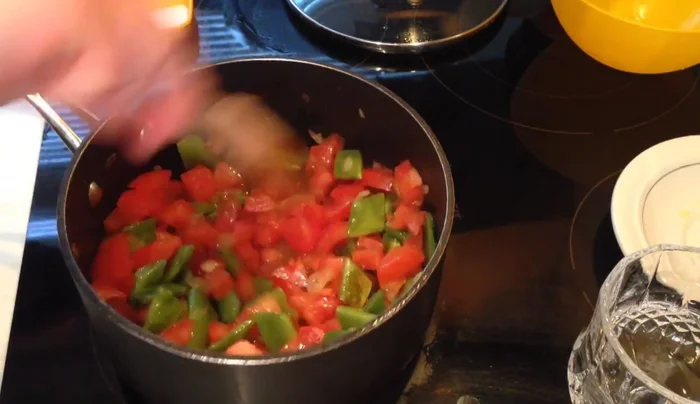Add the diced tomatoes, salt, and less than half a cup of water. Dissolve the tomato paste in the water and add to the pot.