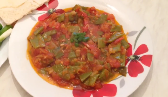 Serve warm or cold with pita bread, spring onions, regular onions, radish (optional), cucumbers, and green bell peppers.