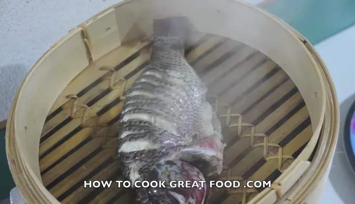 Transfer the steamed fish to a plate.