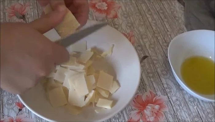 Add grated cheese in strips around the edge of the pizza dough, folding the edges over the cheese.