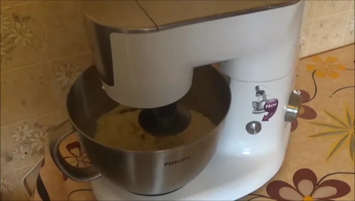Gradually add water, mixing until a homogeneous dough forms.