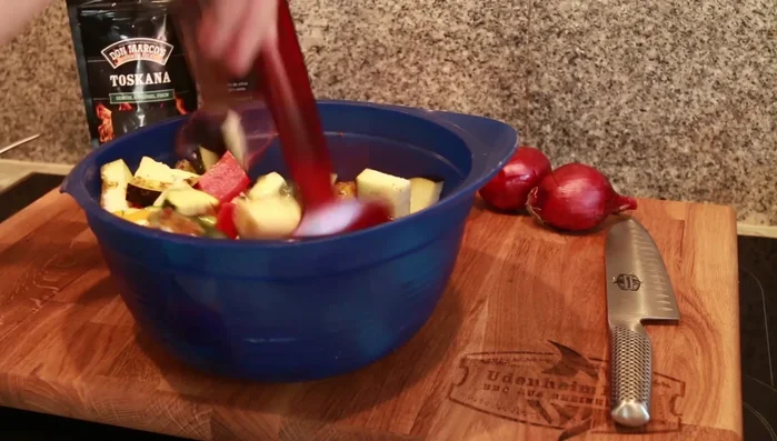 Add red onions: Cut red onions into 1-inch pieces and add to the bowl. Stir to combine.