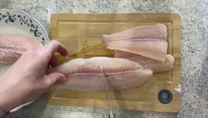 Cut the fish fillets in half and season with salt.