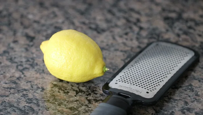 Use a microplane to zest one lemon and add it to the pan.