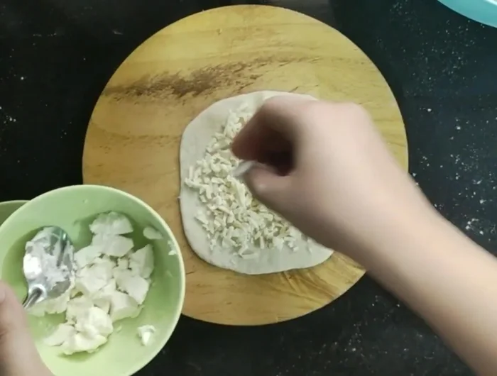 Add toppings: Spread the zatar mixture evenly over each circle. Sprinkle with mozzarella cheese and nigella seeds.