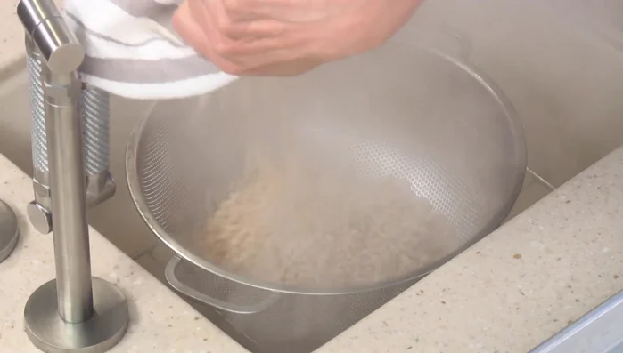 Drain the cooked barley and spread it on a sheet tray to cool for 15 minutes.