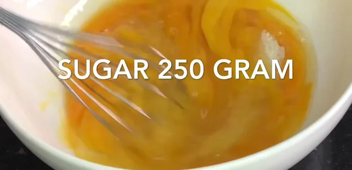 Mix 6 eggs, 250 grams of sugar, and beat well. Add 250 grams of oil and beat. Add 2 tablespoons of vanilla essence and mix.