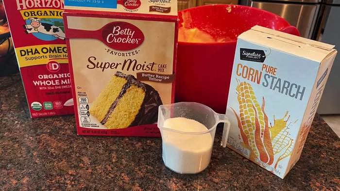 Prepare the boxed cake mix as directed on the package. Pour into a greased circular pan or Pyrex dish and bake.
