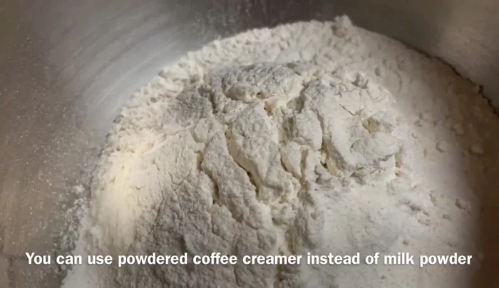 In a bowl, combine all-purpose flour, salt, milk powder, oil, egg, and the yeast mixture. Mix with a spoon.