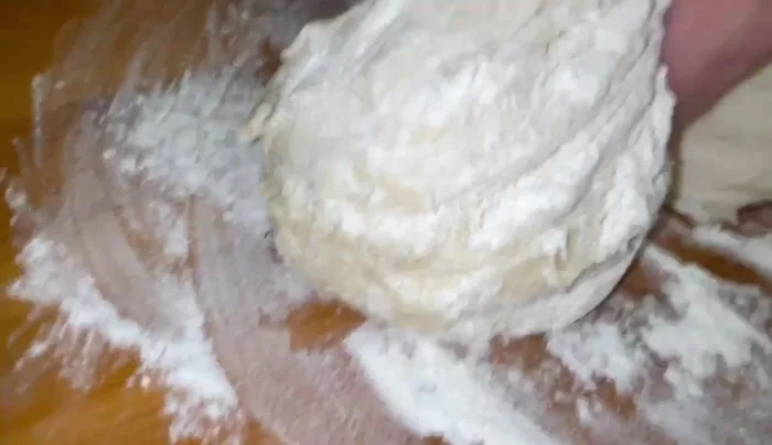 Transfer the dough to a floured surface, divide it into equal pieces, and place each on a parchment-lined baking sheet. Roll each piece into a thin circle.