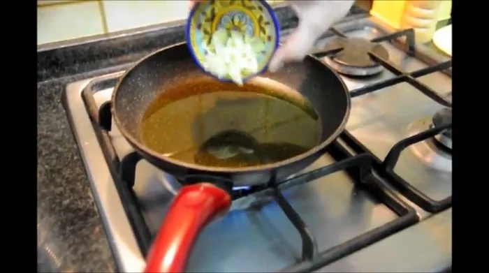 Add sliced garlic to the hot oil.