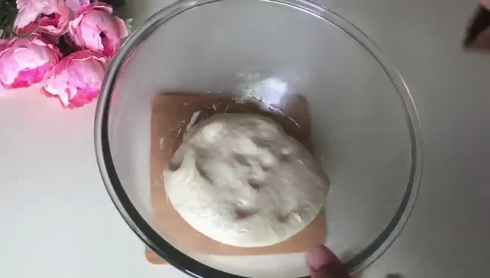 After proofing, lightly oil a surface and roll out the dough.