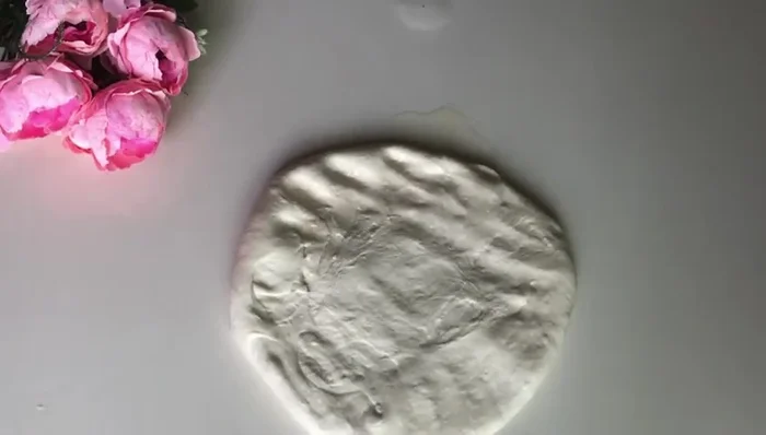 Stretch and spread the dough into a large, thin circle.