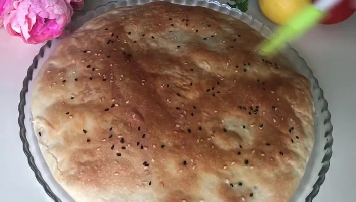 Immediately after baking, lightly press the bread and optionally brush with butter or ghee. Cover for 5 minutes to steam.