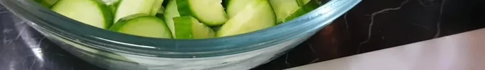 Place the sliced cucumbers in a bowl.