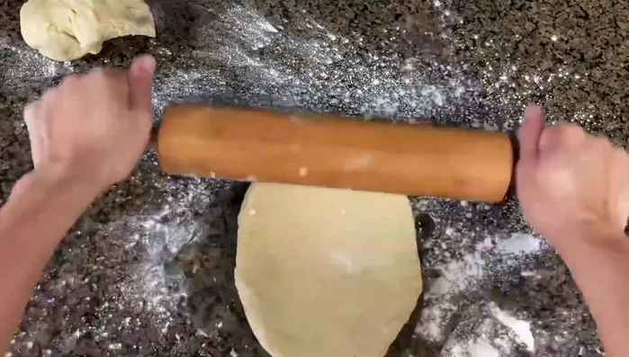 After one hour, roll out the dough thinly and cut into round shapes.
