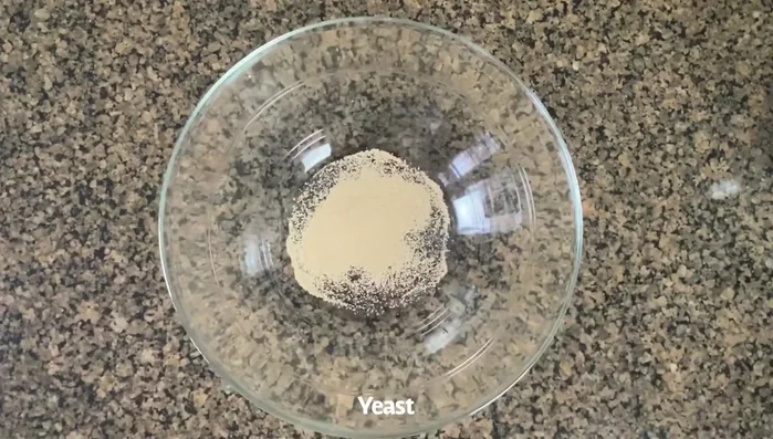 Activate yeast with sugar and warm milk. Set aside for a few minutes.