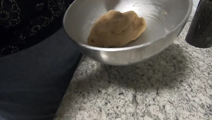 Knead the dough on a lightly oiled surface until smooth and elastic. Punching the dough helps control it.