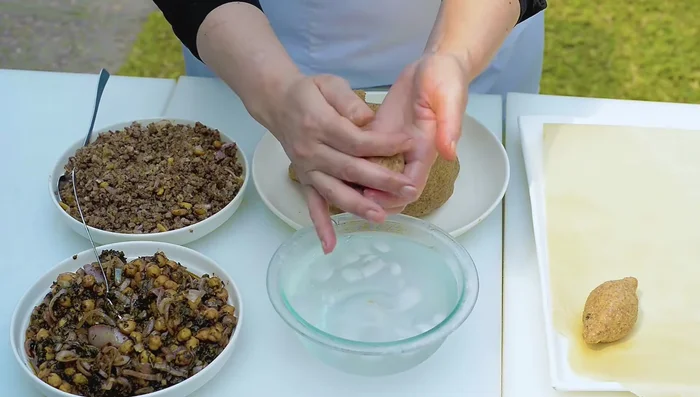 Fill the kibbeh cups with the cooled vegan filling, seal, and shape into ovals. Add cold water if needed to seal.