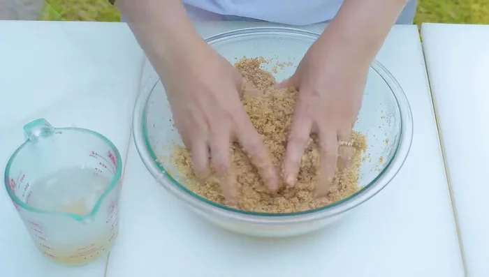 Knead the hydrated bulgur, gradually adding ice water until a cohesive dough forms.