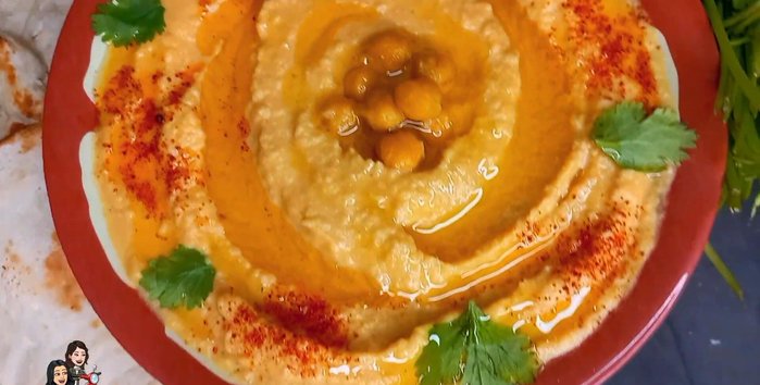 Serve the warm khubz with hummus and a side salad. (228.36)