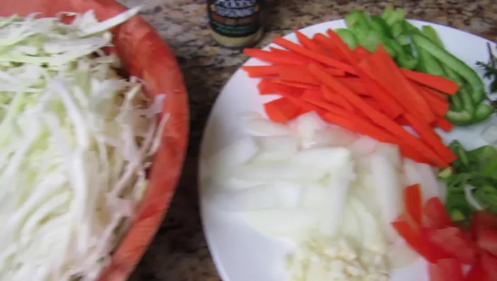 Stir-fry cabbage (white, purple, or a mix) with scotch bonnet pepper, tomato, scallion, thyme, bell pepper, carrot, onion, garlic, purple seasoning, and unrefined coconut oil.