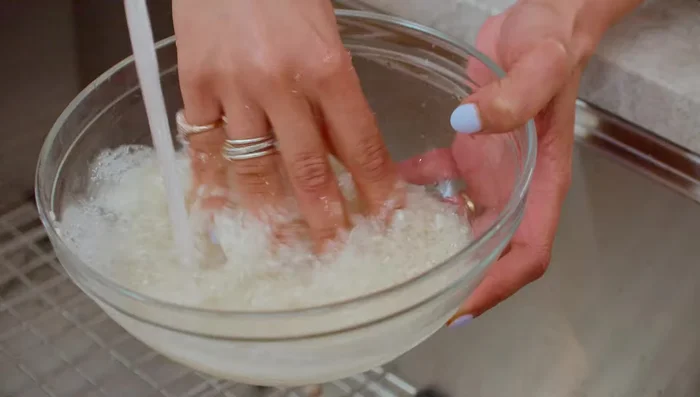 In a pot, combine the washed and soaked rice (soak for 15-20 minutes), partially cooked lentils, water, kosher salt, and cumin. Bring to a boil. (124.64)