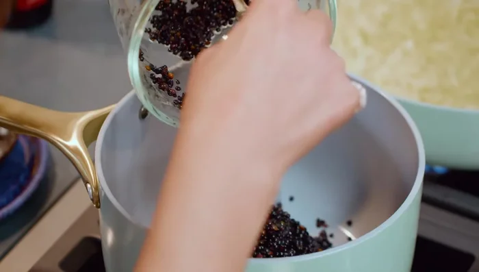 Rinse one cup of black lentils. In a pot, simmer the lentils with two cups of water for about 10 minutes. (52.44)