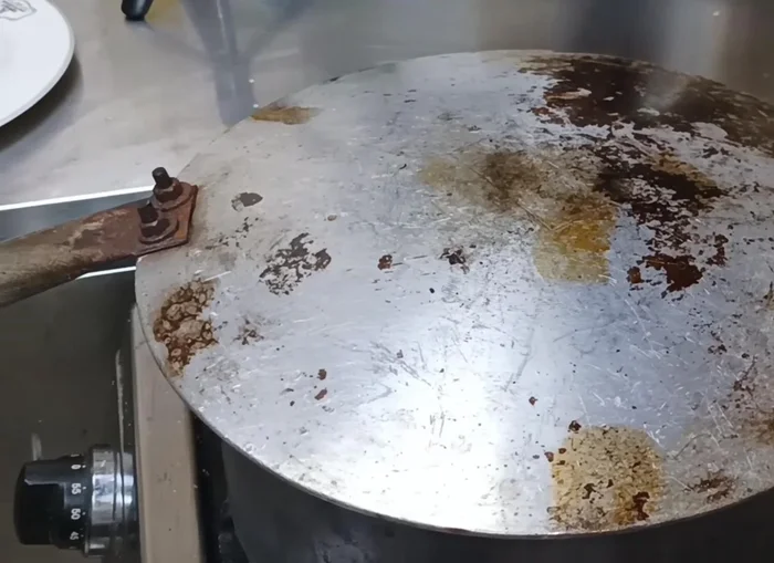Flip the bread to cook the other side, using a stand for support if needed.