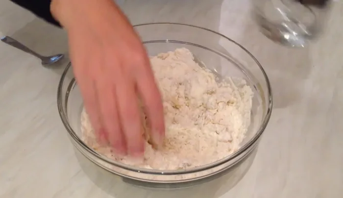 Gradually add warm water, knead into a soft dough.