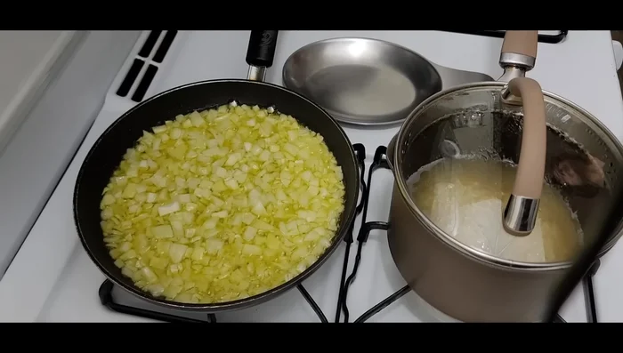 In a medium-sized frying pan, sauté 2 cups of chopped onions in 1/2 cup of olive oil until golden brown. (140.599)