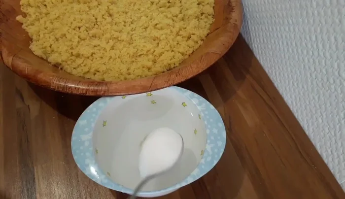 Add salt and sugar to the semolina and oil mixture.