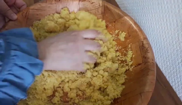 Gradually add water, mixing gently to avoid over-kneading. The goal is to form a dough without actively kneading it.