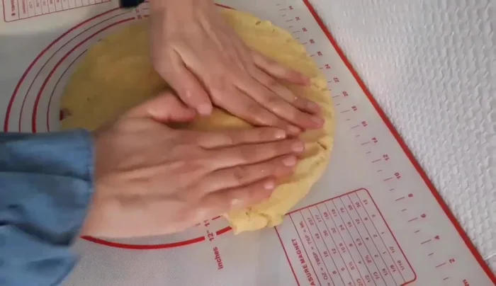 On a lightly oiled baking sheet, shape the dough into desired forms. The speaker uses a cookie cutter to create shapes, but you can also form rectangles or diamonds.