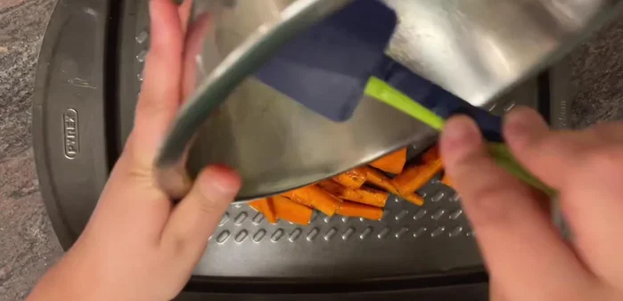Place carrots on a baking tray, ensuring all the spice and oil from the bowl is used.